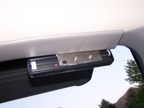 2003 Ford Crown Victoria - An interior shot shows a light fixture attached to the car's headliner, with visible mounting hardware.