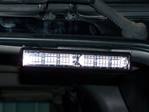 2003 Ford Crown Victoria - An aftermarket LED light bar is installed above the interior windshield.