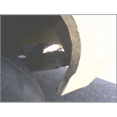 1972 Ford Ranchero - A damaged wheel well shows a hole allowing light to pass through.