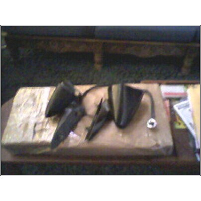 1972 Ford Ranchero - Several car side mirrors are laid out on a table, possibly for replacement or sale.