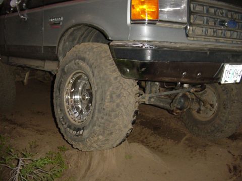 1989 Ford Bronco - Tire up on a stump