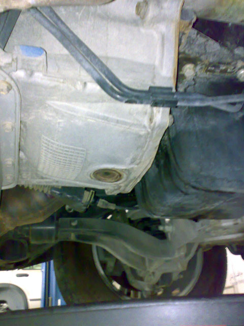 2007 Mercury Grand Marquis - Undercarriage view of a vehicle, focusing on the transmission and suspension system.