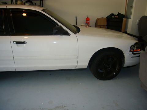2000 Ford Crown Victoria - Side view of a white 2000 Ford Crown Victoria in a garage.