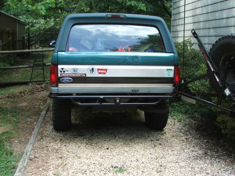 1996 Ford Bronco - The rear of a green Ford Bronco shows various stickers, including 'Independent4x' and 'Warn'.