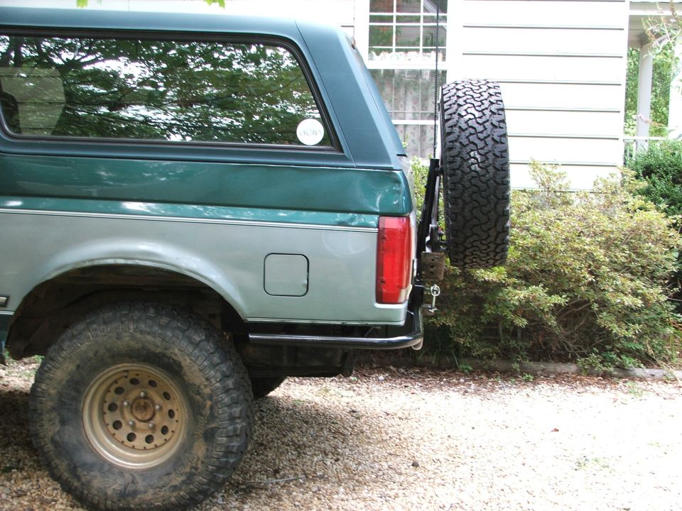 Green and silver Ford Bronco rear with spare tire mounted externally