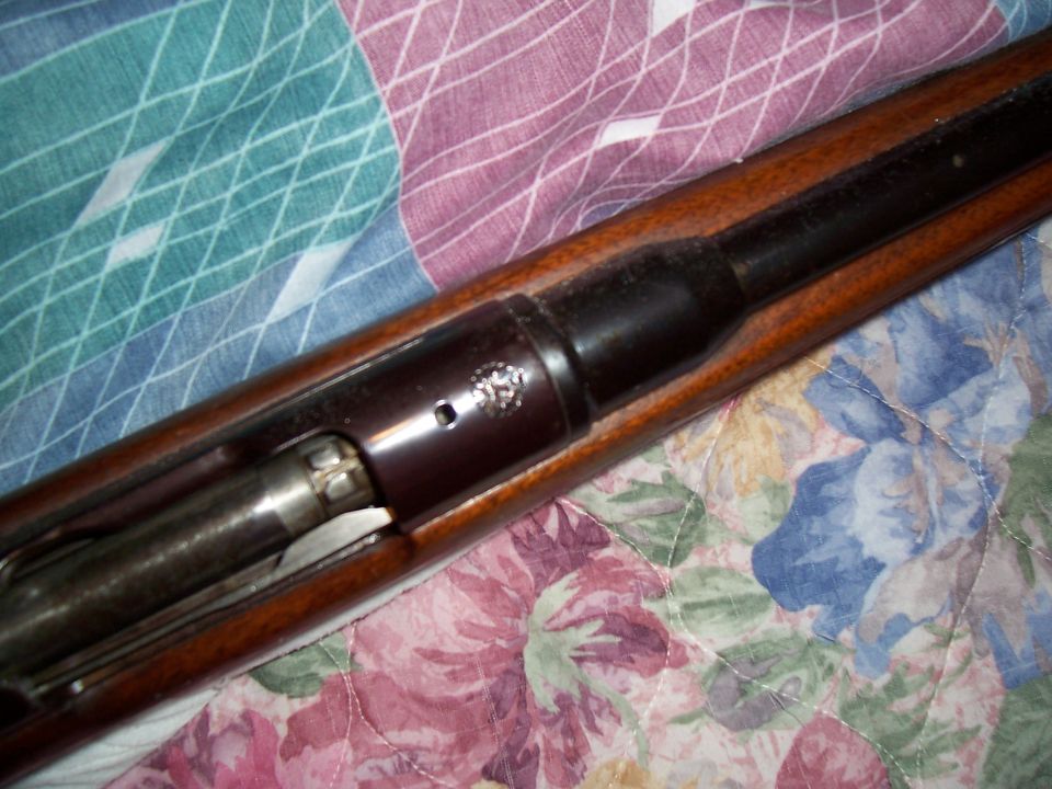 close-up of a rifle's wooden stock and metal action