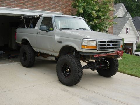 1995 Ford Bronco - This lifted 1995 Ford Bronco features oversized off-road tires and a modified suspension system, giving it an aggressive stance.