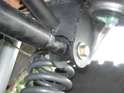 1995 Ford Bronco - Close-up view of a vehicle's suspension system, showing a coil spring and part of a tire. The Supermotors.net logo is visible in the lower…