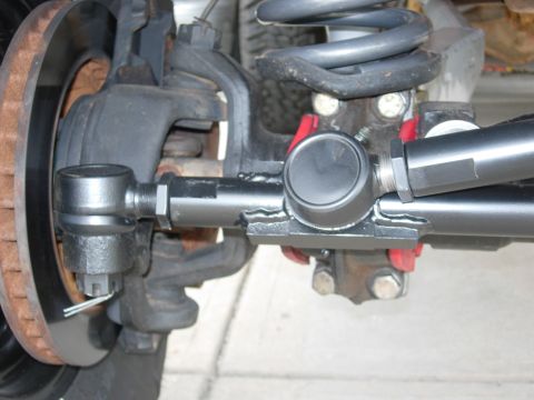 1995 Ford Bronco - Close-up view of the steering linkage and suspension components of a vehicle.