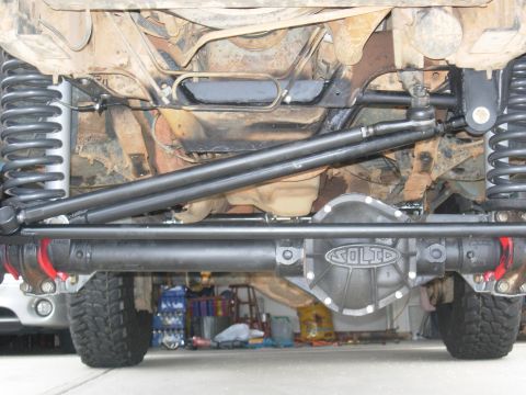1995 Ford Bronco - The underside of a modified SUV reveals a Solid axle differential and robust suspension components.