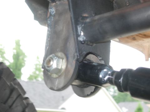 1995 Ford Bronco - Detail of a vehicle's suspension system, a bolted bracket and metal tubing.