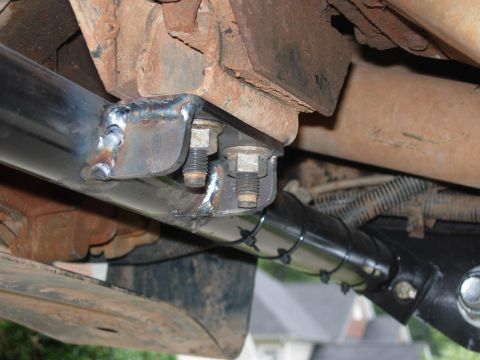 1995 Ford Bronco - Custom suspension work with visible welds and hardware on a vehicle's undercarriage.