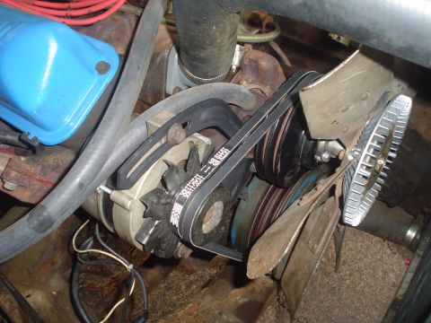 1967 Ford F-250 - Engine compartment view showing the alternator, fan, and drive belts.