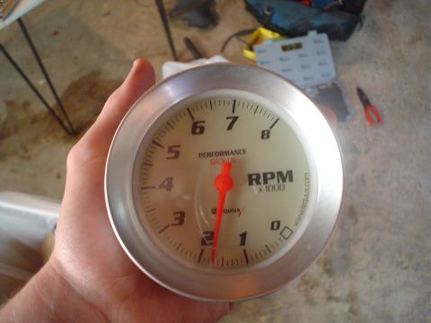 1967 Ford F-250 - A tachometer gauge is held in a hand, showing RPM readings up to 8000.