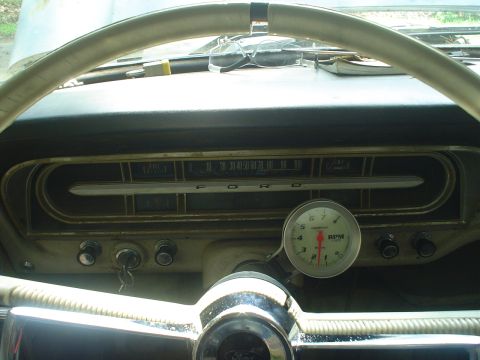 1967 Ford F-250 - The interior of a 1967 Ford F-250 truck is visible, focusing on the dashboard and steering wheel.