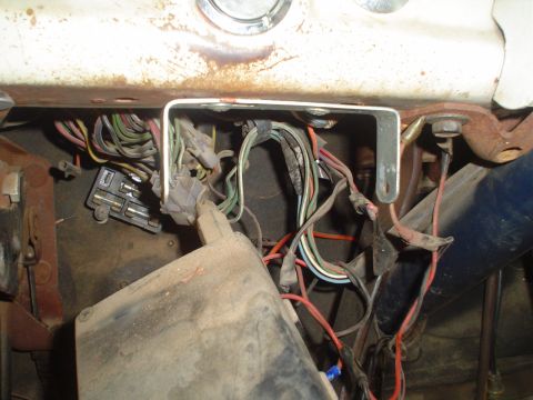 1967 Ford F-250 - The complex and disorganized wiring harness of an older vehicle's dashboard.