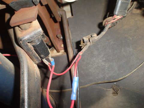 1967 Ford F-250 - A close-up view of vehicle wiring and a rusty bracket, showing electrical connections and mechanical components.
