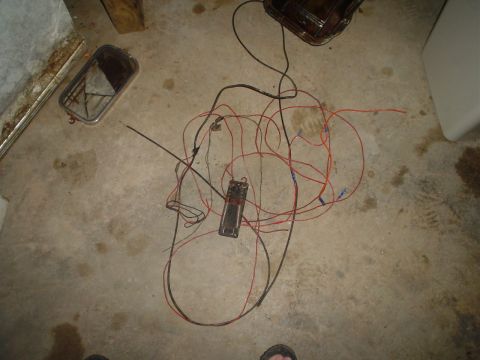 1967 Ford F-250 - A messy bundle of wires and an electrical component lie on a concrete surface.