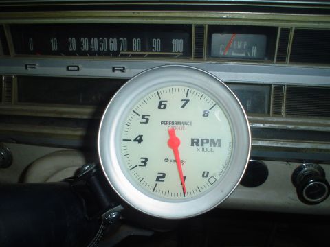 1967 Ford F-250 - Close-up of a vehicle's dashboard a tachometer and other gauges.