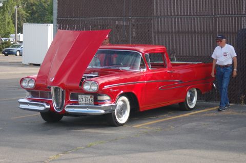 1967 Ford Ranchero - A man stands next to a bright red 1958 Edsel Pacer pickup truck with its hood open.