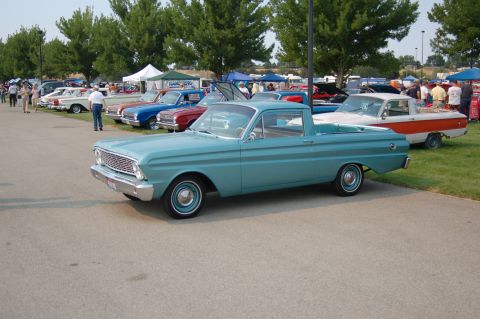 1967 Ford Ranchero - A row of classic vehicles are displayed at an outdoor car show.