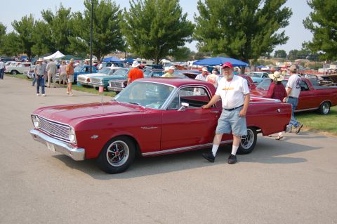 1967 Ford Ranchero - A man poses with his red 1967 Ford Ranchero at the Northwest MotorFest car show.