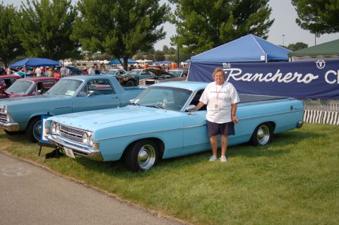1967 Ford Ranchero - A light blue 1968 Ford Ranchero is displayed at an outdoor car show with a person standing beside it.