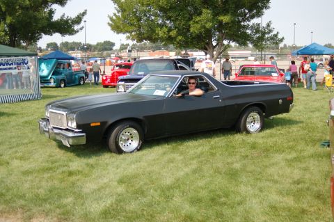 1967 Ford Ranchero - A black 1977 Ford Ranchero is displayed at the Northwest MotorFest, with a driver behind the wheel.