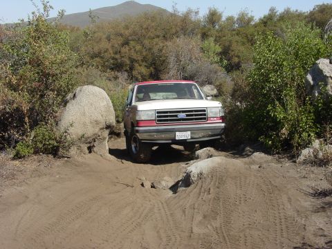 1994 Ford Bronco - Ford Bronco tackles rough terrain on a sunny day.