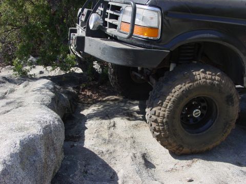1994 Ford Bronco - This truck is navigating a challenging rocky path, its off-road capabilities.