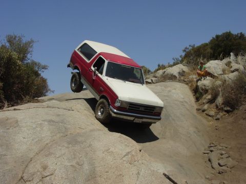 1994 Ford Bronco - This 1994 Ford Bronco is tackling a challenging off-road trail with steep rock formations.