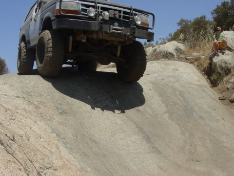 1994 Ford Bronco - A lifted 1992 Ford Bronco navigates a rocky trail, its off-road capabilities.