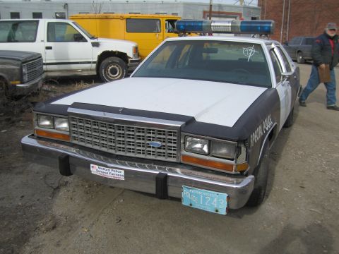 1991 Ford LTD Crown Victoria - Front view of a 1991 Ford Crown Victoria LTD police car parked outdoors with other vehicles.