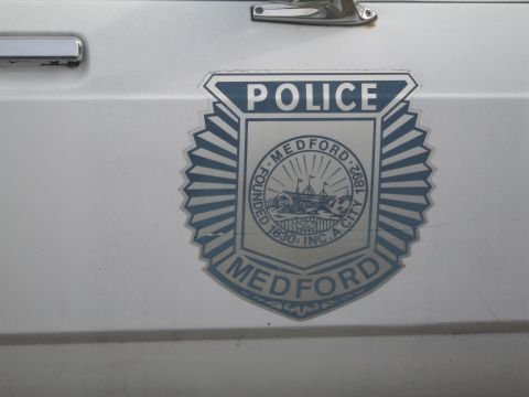 1991 Ford LTD Crown Victoria - Close-up of a Medford Police Department emblem affixed to the side of a vehicle.