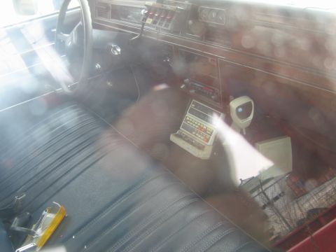 1991 Ford LTD Crown Victoria - Interior view of a car, a calculator and CB radio on the dashboard.