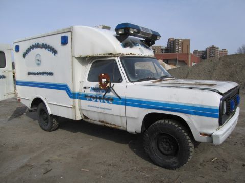 1991 Ford LTD Crown Victoria - A white police van with 'Medford Police' markings is parked outdoors.