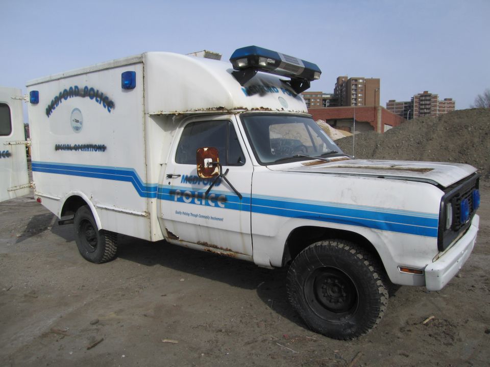 White police van with blue stripes and lights, marked 'Medford Police Special Operations'