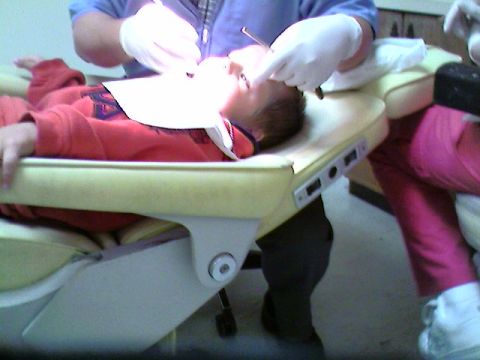 1989 Ford Bronco - A child is undergoing a dental examination while lying in a dental chair.