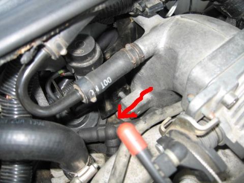 1995 Mercury Cougar - This image shows various engine components, including hoses and a part of the intake manifold.