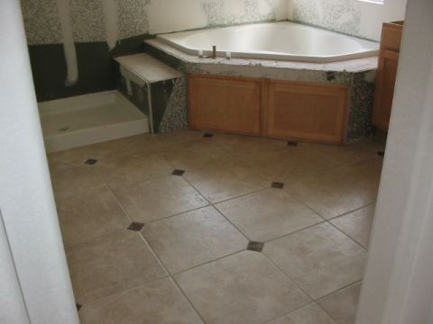 1995 Ford Bronco - Bathroom renovation in progress, showing a corner tub, shower base, and unfinished tile work.