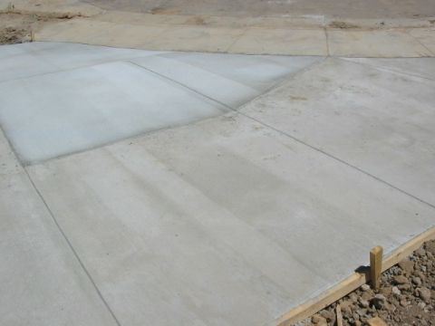 1995 Ford Bronco - Newly poured concrete driveway sections with visible expansion joints and wooden forms in place.