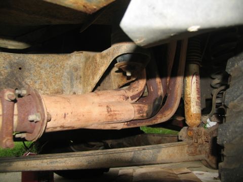 1978 Ford Bronco - Undercarriage view of rusted exhaust and suspension parts.