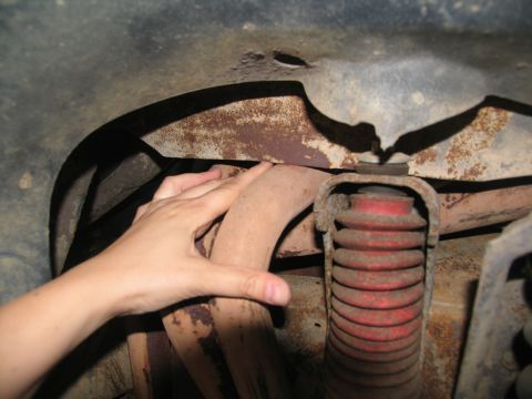 1978 Ford Bronco - Close-up view of vehicle undercarriage showing exhaust pipe and suspension components.