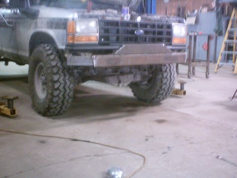 1990 Ford Ranger - The front grille and custom bumper of a 1990 Ford Ranger are visible in this workshop photo.