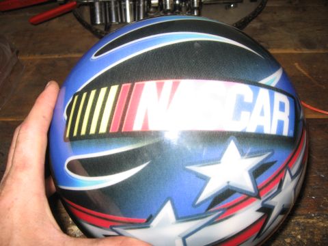 1974 Ford F-100 - A close-up view of a blue helmet adorned with stars, stripes, and the NASCAR logo.