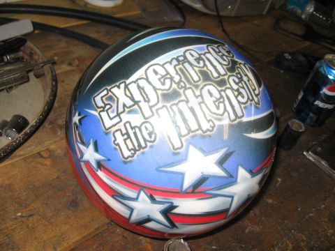 1974 Ford F-100 - Helmet with patriotic stars and stripes paint and 'Experience the Intensity' text.