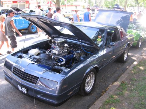 1989 Ford Mustang - Customized 1980s Chevrolet Monte Carlo SS with a prominent supercharger and aftermarket wheels.