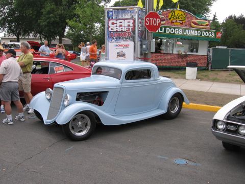 1989 Ford Mustang - A light blue coupe hot rod is parked at an outdoor event with other vehicles and people.