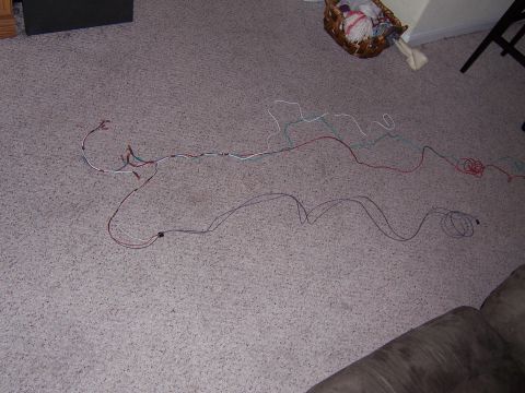 1995 Ford Bronco - A collection of wires and connectors are spread across a carpeted floor.