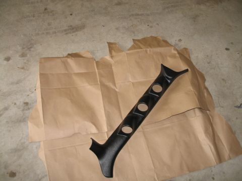 1995 Ford Bronco - A black plastic A-pillar gauge pod with three circular openings is displayed on brown paper.